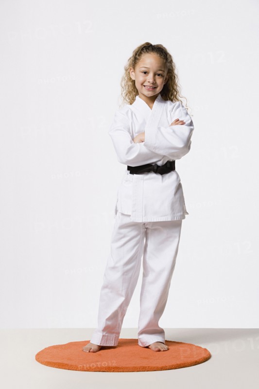Girl (8-9) wearing gi, studio shot. Photo : Rob Lewine