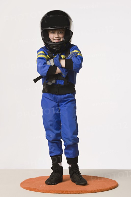 Studio portrait of girl (8-9) in crash helmet. Photo: Rob Lewine
