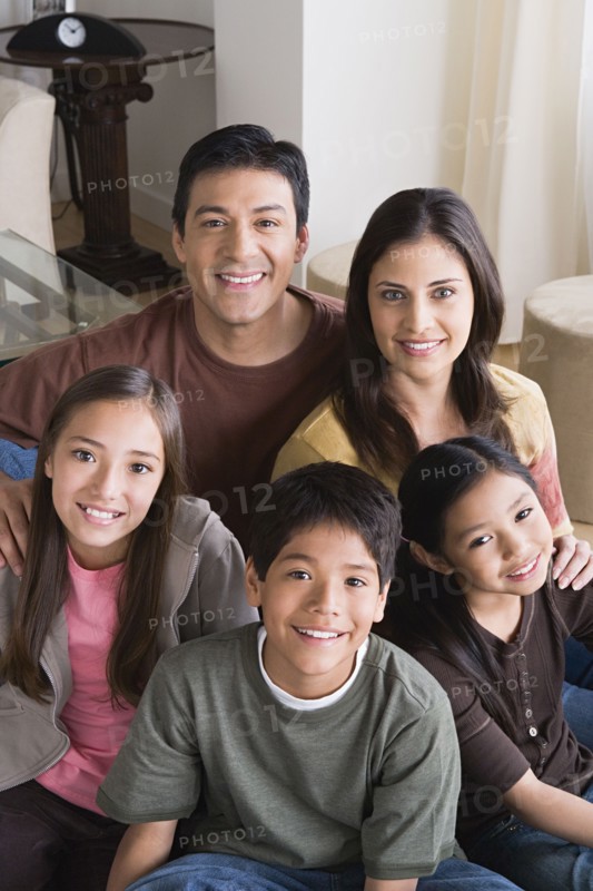 Portrait of happy family with three children (8-9, 10-11). Photo: Rob Lewine