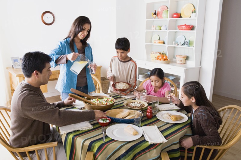 Family with three children (8-9, 10-11) dining together. Photo: Rob Lewine
