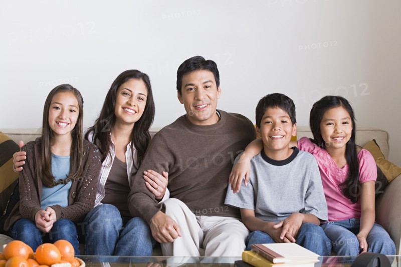 Portrait of happy family with three children (8-9, 10-11). Photo: Rob Lewine