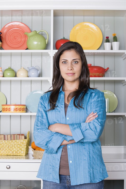 Portrait of smiling woman in kitchen. Photo : Rob Lewine