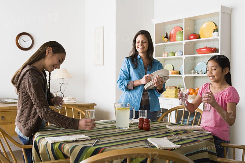 Mother with two daughters (8-9, 10-11) in kitchen. Photo : Rob Lewine
