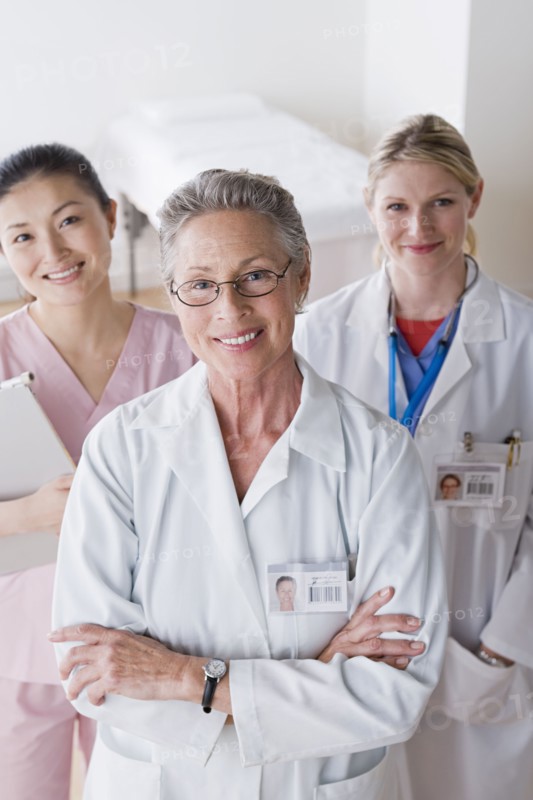 Portrait of three smiling female doctors. Photo : Rob Lewine