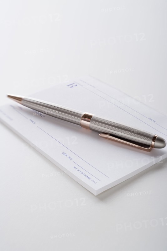 Close up of pen and blank prescriptions, studio shot. Photo : Rob Lewine