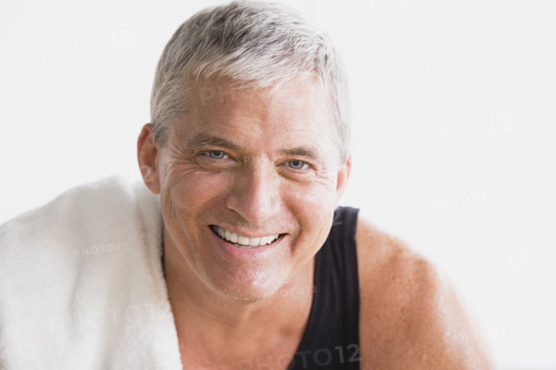 Portrait of smiling mature man in gym. Photo : Rob Lewine
