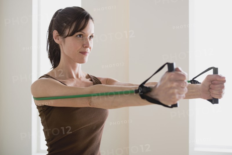 Woman exercising with resistance band. Photo: Rob Lewine