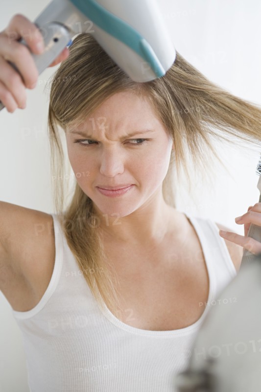 Woman drying hair. Photo: Rob Lewine