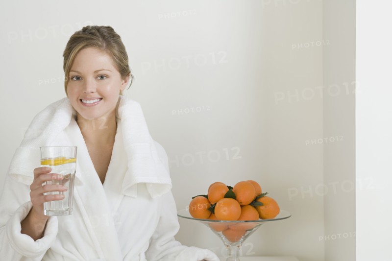 Relaxed woman drinking water. Photo : Rob Lewine