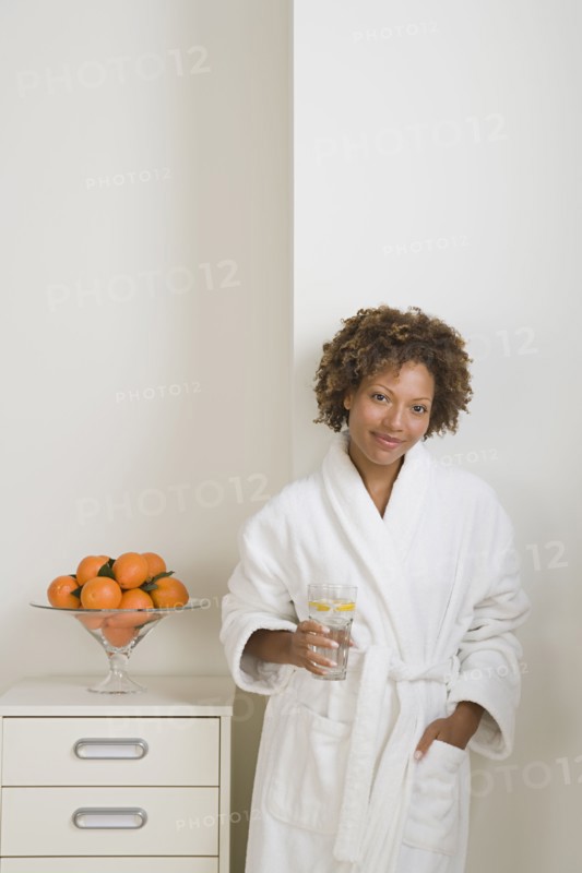 Attractive woman drinking fresh orange juice. Photo : Rob Lewine