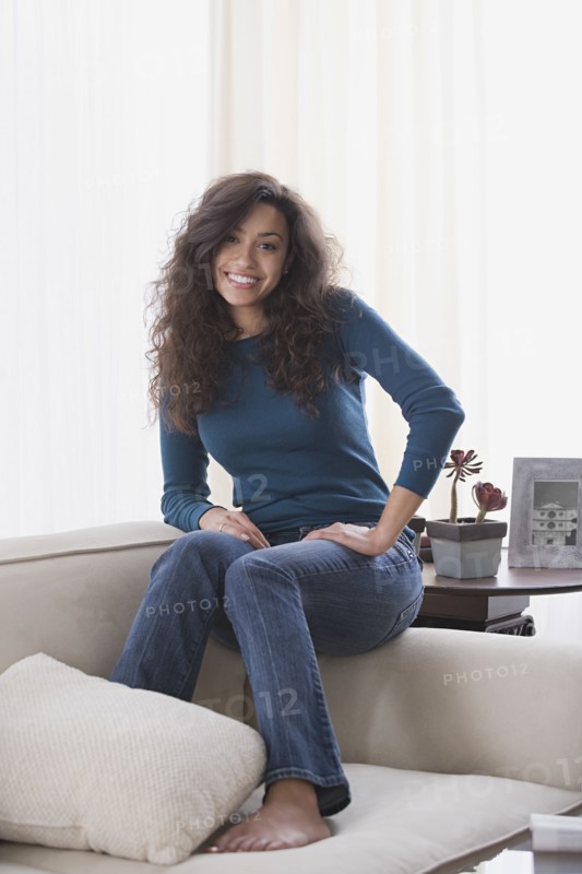 Woman relaxing on sofa. Photo : Rob Lewine