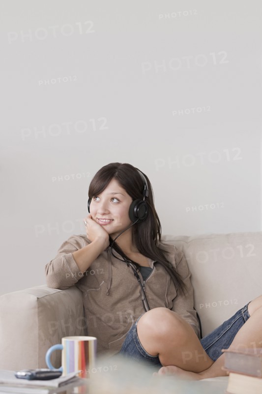Woman relaxing on sofa. Photo : Rob Lewine