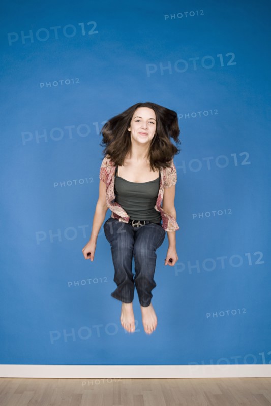 Portrait of teenage girl (16-17) jumping. Photo : Rob Lewine