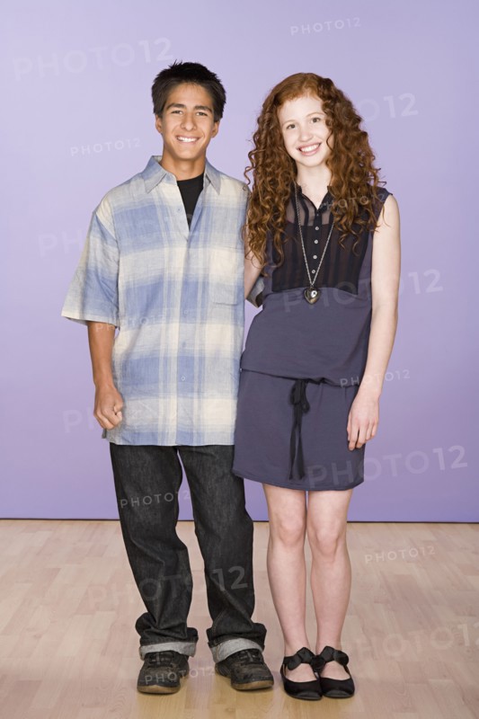 Portrait of teenage (16-17) girl and teenage boy (16-17) standing together. Photo : Rob Lewine