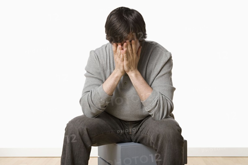 Studio portrait of young man crying. Photo : Rob Lewine