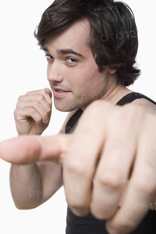 Studio portrait of young man punching air. Photo: Rob Lewine