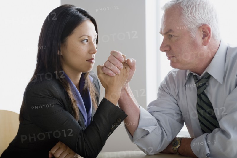 Business people arm wrestling. Photo: Rob Lewine