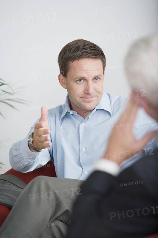 Two businessmen talking. Photo : Rob Lewine