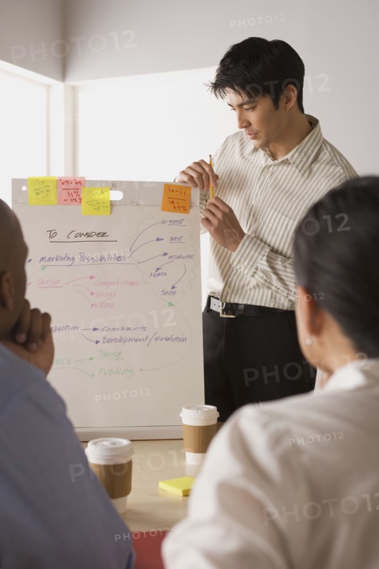 Group of businesspeople in meeting. Photo : Rob Lewine