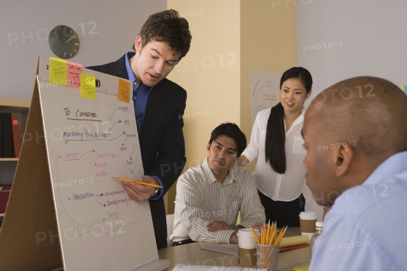 Group of businesspeople in meeting. Photo : Rob Lewine