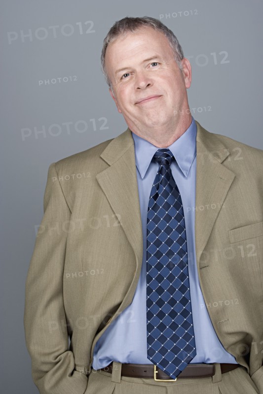 Portrait of happy mature businessman. Photo : Rob Lewine