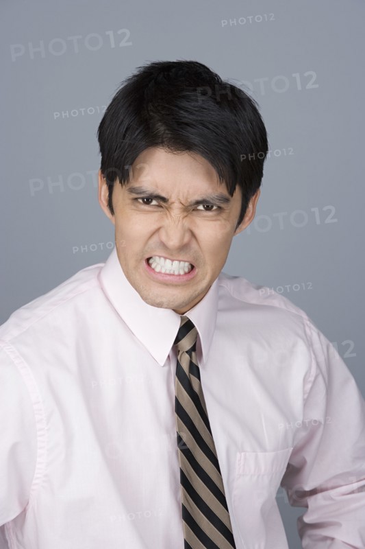 Portrait of young businessman pulling funny faces. Photo : Rob Lewine