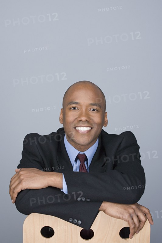 Portrait of happy mid adult businessman. Photo : Rob Lewine