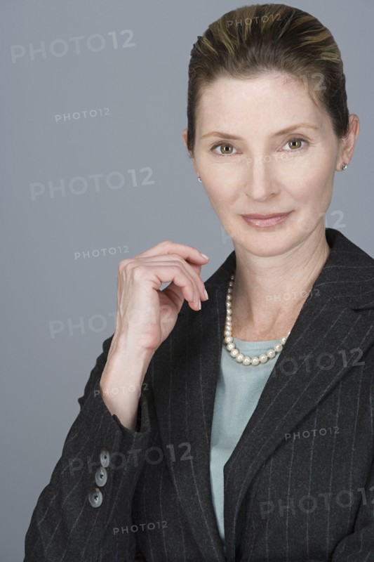 Portrait of cheerful mature businesswoman. Photo : Rob Lewine