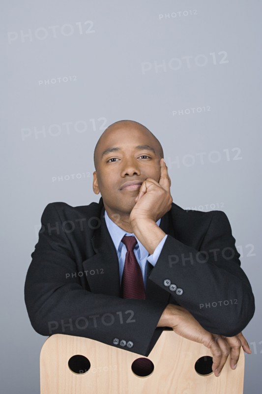 Portrait of happy mid adult businessman. Photo : Rob Lewine