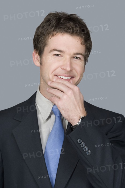 Portrait of happy young businessman. Photo : Rob Lewine