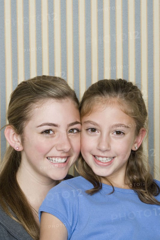 Portrait of two happy girls (14-15, 8-9). Photo : Rob Lewine
