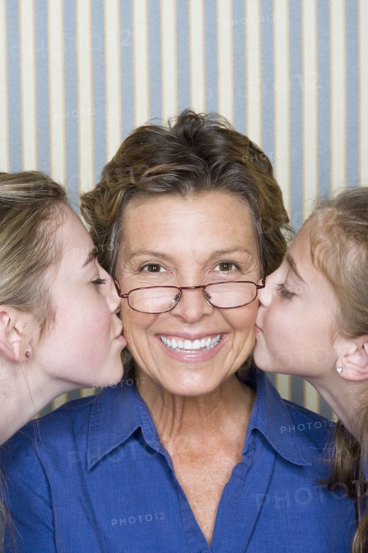 Portrait of father being kissed by two girls (8-9, 14-15) . Photo: Rob Lewine