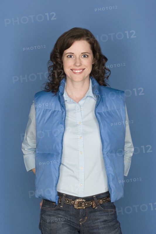 Portrait of happy mid adult woman wearing blue vest. Photo: Rob Lewine