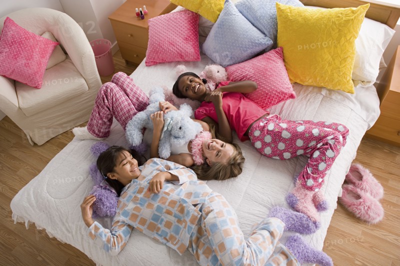 Three girls (10-11) having fun at slumber party. Photo: Rob Lewine