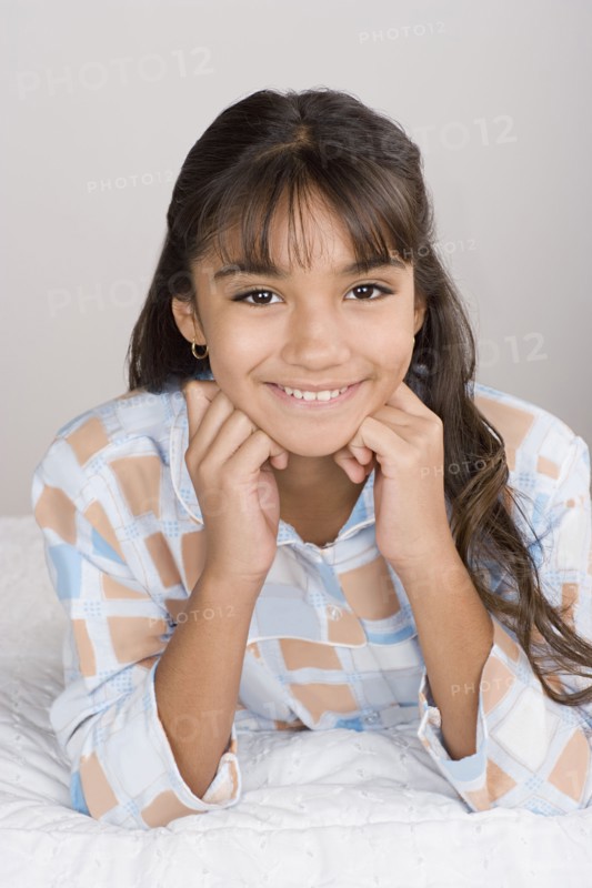 Portrait of smiling girl (10-11) in pajamas. Photo : Rob Lewine