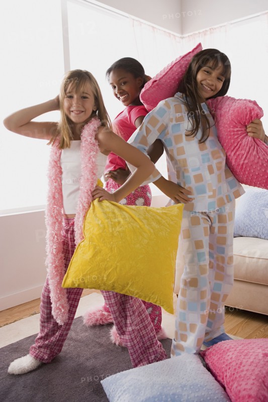 Portrait of three girls (10-11) playing at slumber party. Photo: Rob Lewine