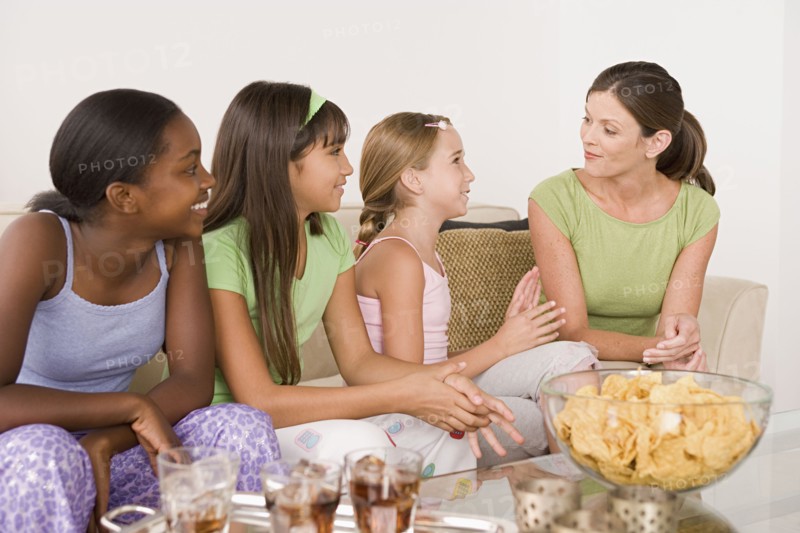 Three girls (10-11) and woman at slumber party. Photo: Rob Lewine