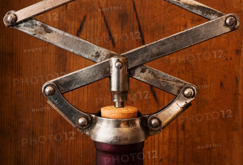 Studio shot of corkscrew opening bottle.