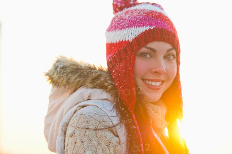 Portrait of young woman wearing knit hat.