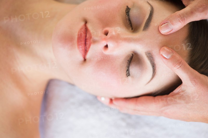 Woman receiving face massage.