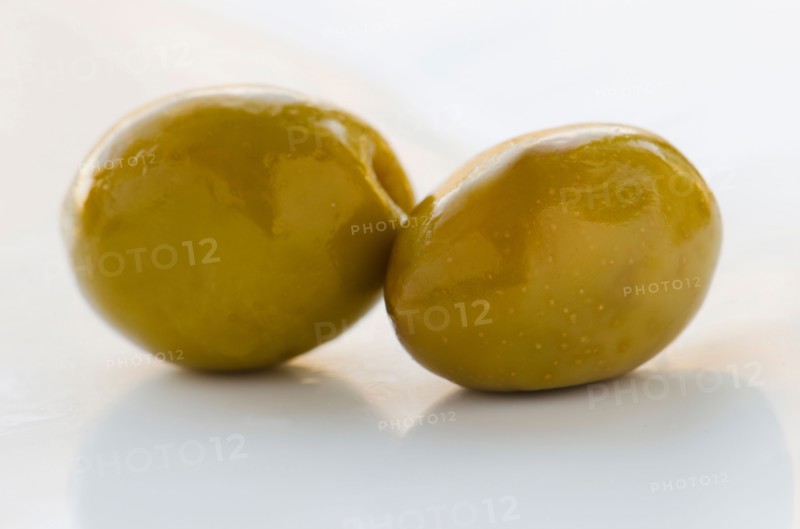 Close-up of green olives, studio shot.