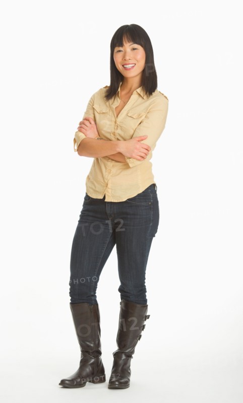 Mid adult smiling woman standing, studio shot.