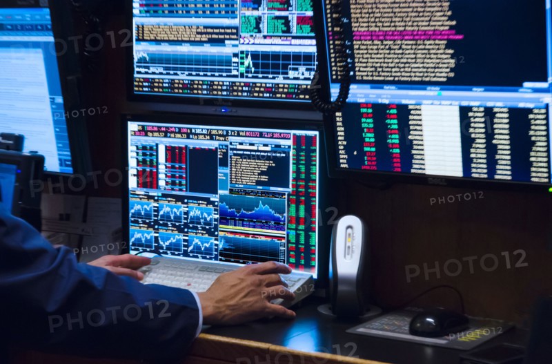 Stock trader working on computer.