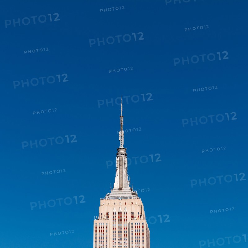 USA, New York, New York City, Empire State Building against blue sky.