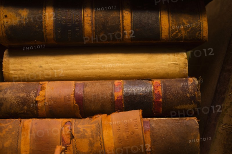 Close up of antique books in leather covers, studio shot.