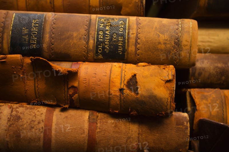 Close up of antique books in leather covers, studio shot.