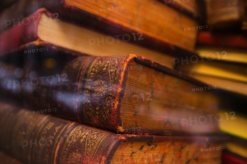 Close up of antique books in leather covers, studio shot.