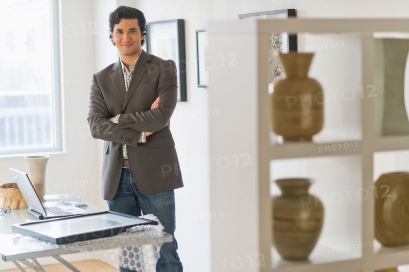 Portrait of man in his art gallery.