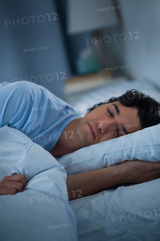 Man sleeping in bed.