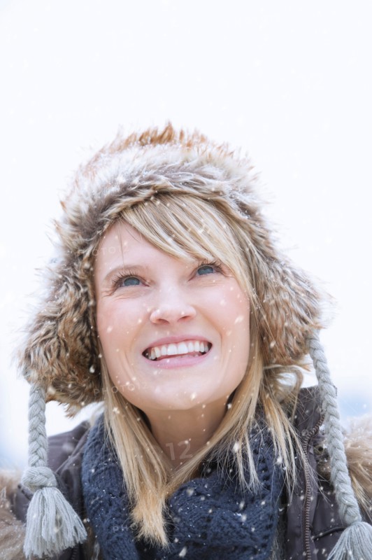 Portrait of woman wearing knit hat smiling.